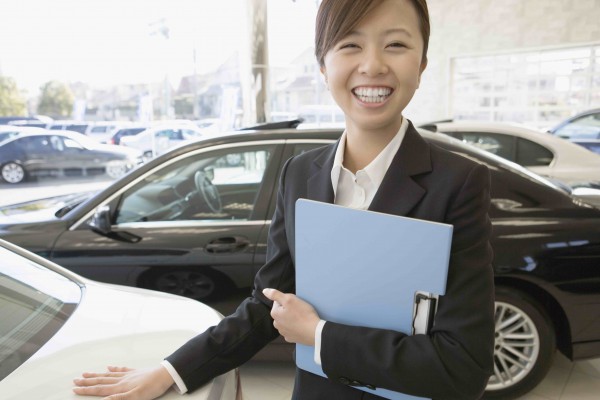 female salesclerk of car dearlership