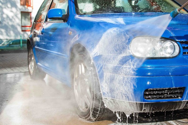 Modern blue car in a car wash